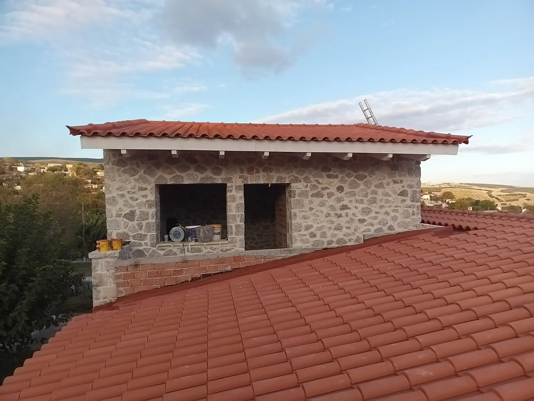 A new Roman-tile energy roof on a stone building, photographed during construction