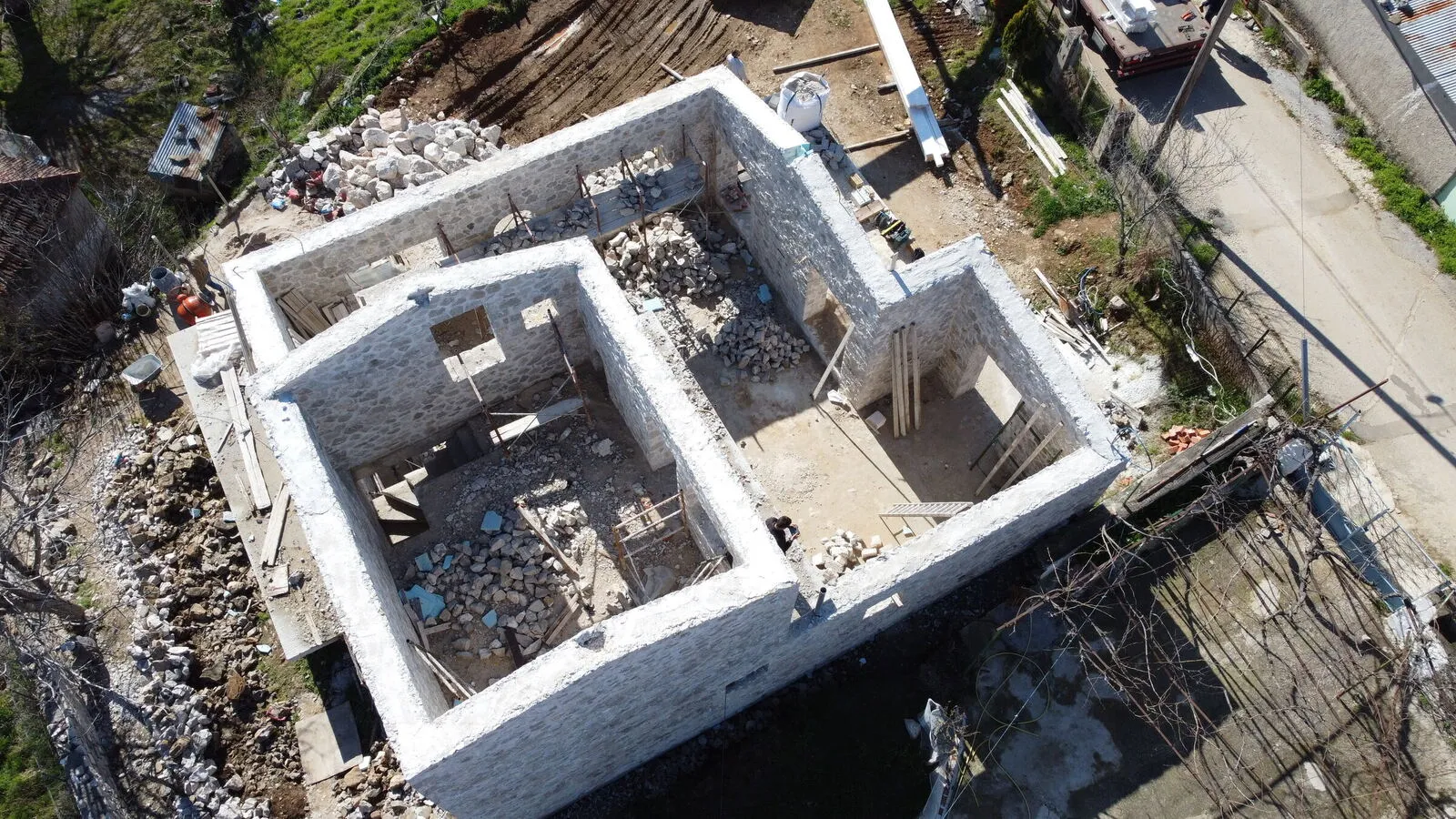 Aerial view of the bare stone walls before the roof installation