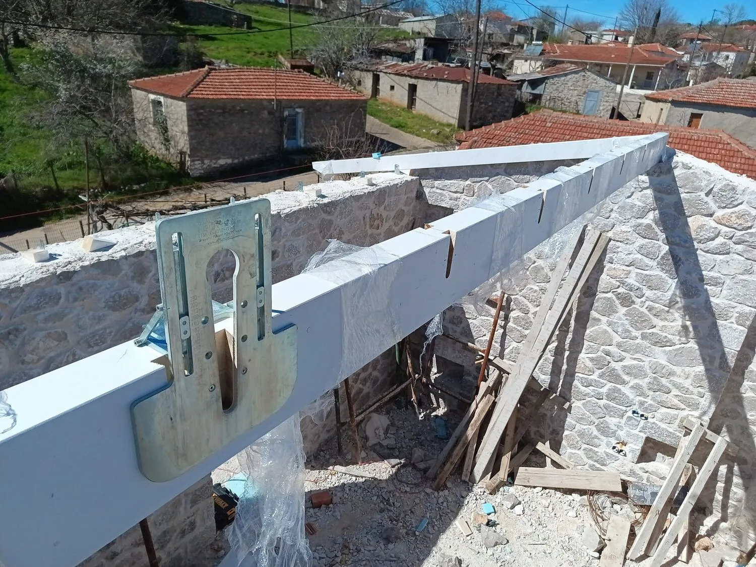 Dovetail joint detail with metal connector and village backdrop