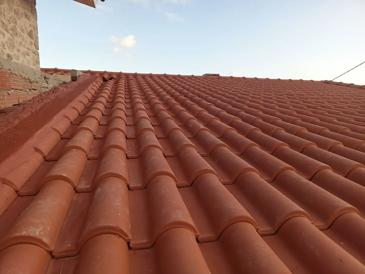 Close detail of the finished terracotta tiles in golden light