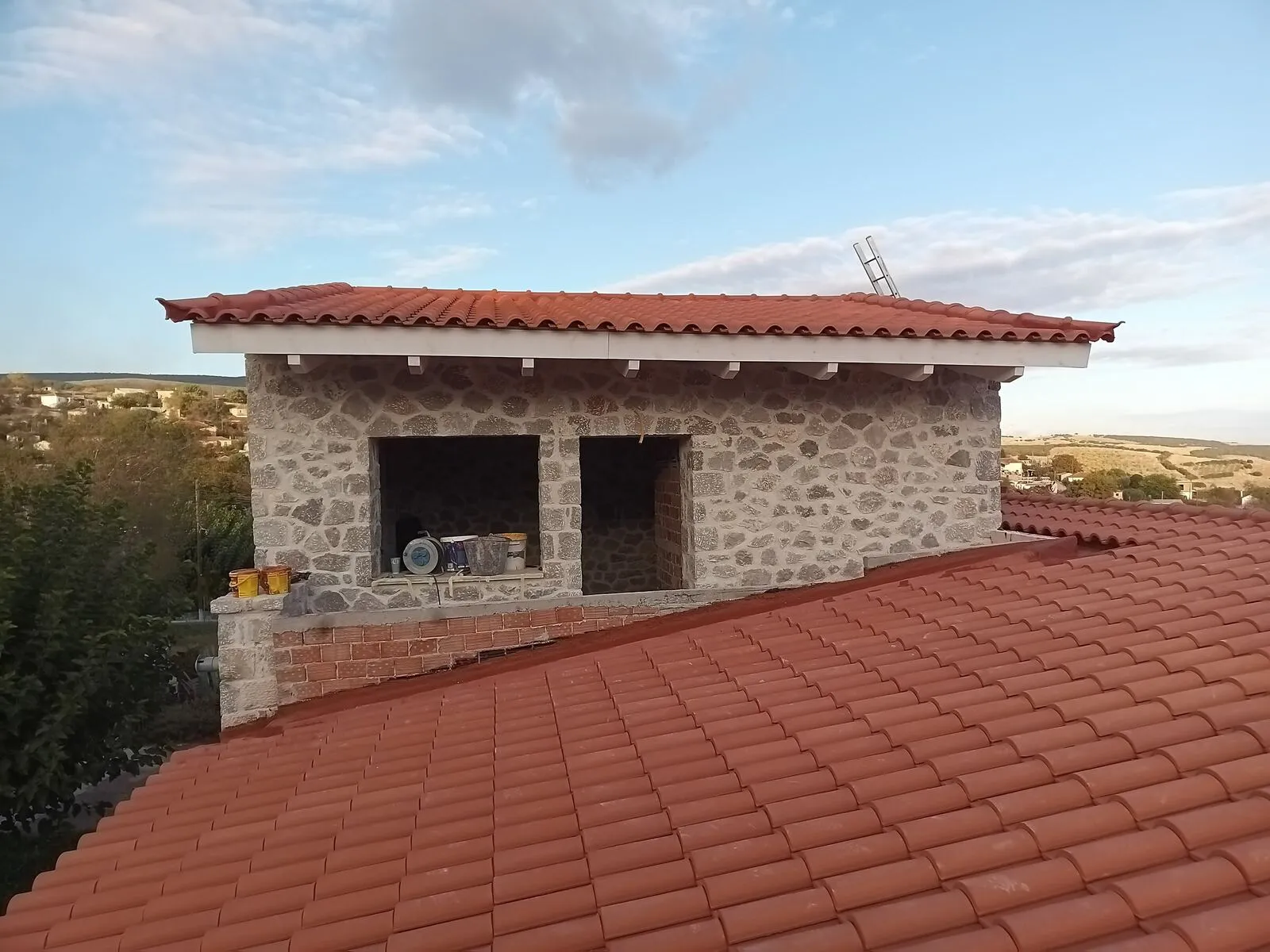 The completed stone house at Petroto Domokou with its new timber roof