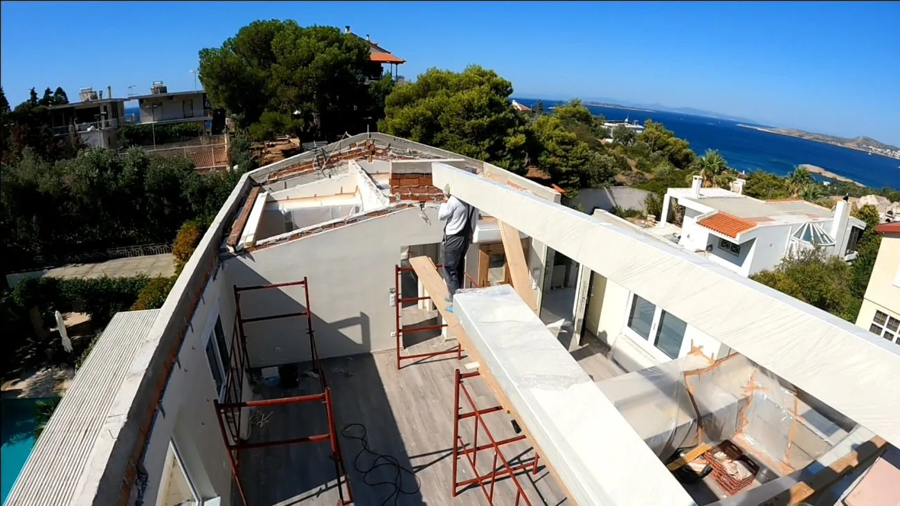 The new GL24 glulam skeleton rising above the Athenian Riviera, Saronic Gulf in the distance.