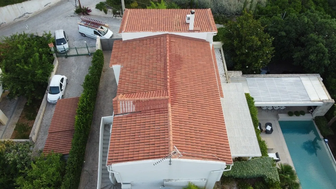 The original failed roof, captured from above. Drone view of the residence before reconstruction.